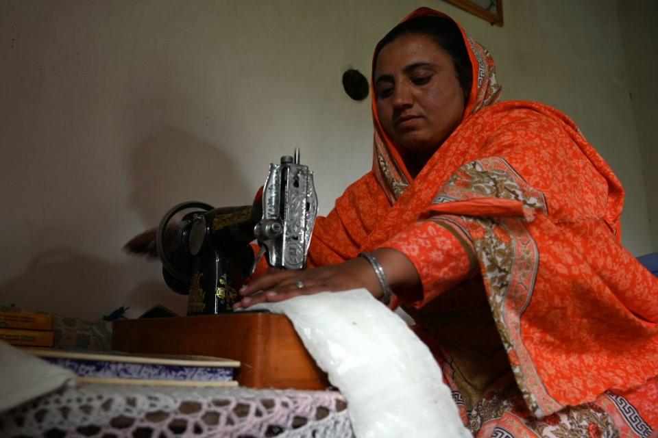 In this picture taken on May 18, 2019, Pakistani woman Hajra Bibi makes a sanitary pad with a sewing machine at her home in Booni village in Chitral.<span class="copyright">AAMIR QURESHI/AFP via Getty Images</span>