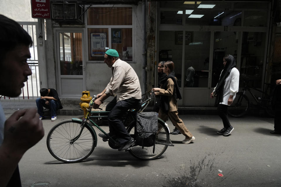 People make their way through the old main bazaar of Tehran, Iran, Thursday, June 13, 2024. The rise of the “Hamster Kombat” app in Iran highlights a harsher truth facing the Islamic Republic's economy ahead of its presidential election this week to replace the late President Ebrahim Raisi, who died in a helicopter crash in May. (AP Photo/Vahid Salemi)