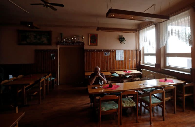 A customer drinks a beer inside a pub in the village of Sec