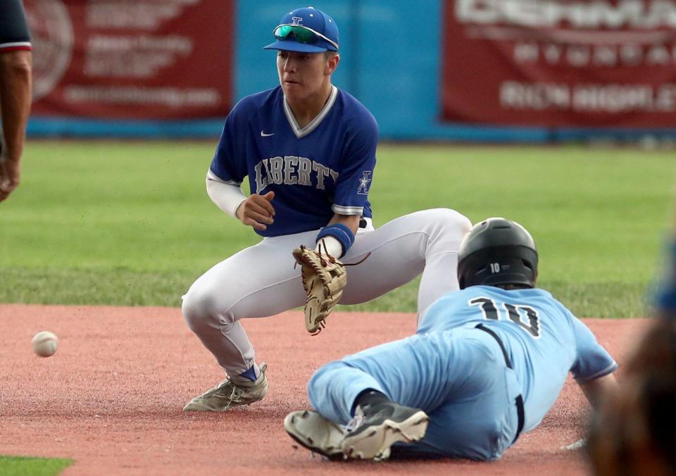 Hilliard Darby's Matt Spencer slides safely into second base before Olentangy Liberty's Mason Onate can secure the ball during a Division I district final May 26 at Grove City. The game was suspended with Darby leading 4-0 in the second inning.