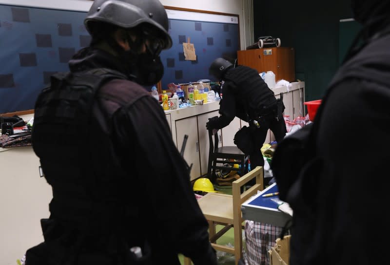 Members of a safety team established by police and local authorities inspect a room at the Hong Kong Polytechnic University (PolyU) in Hong Kong, China