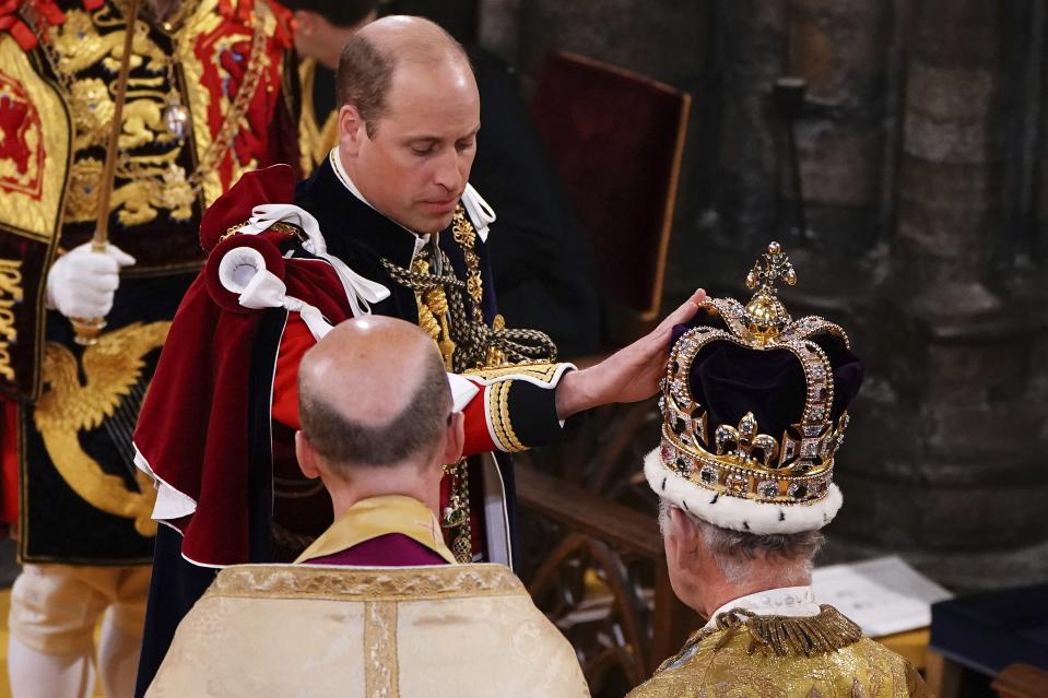 Britain’s Prince William touches St Edward’s Crown on King Charles III’s head during his coronation ceremony in Westminster Abbey, London.