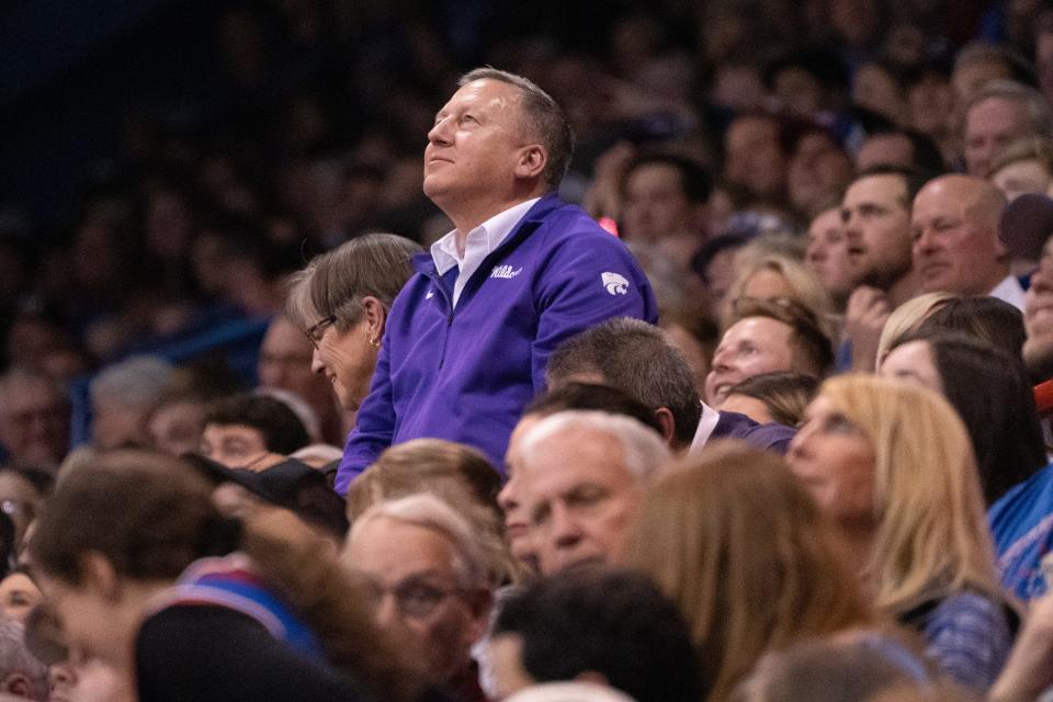 Kansas State president Richard Linton is seen with Gov. Laura Kelly in the stands of Allen Fieldhouse during the Sunflower Showdown in late January.