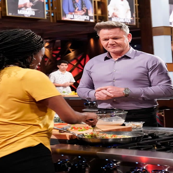 Gordon Ramsey watches a woman cook on Masterchef.