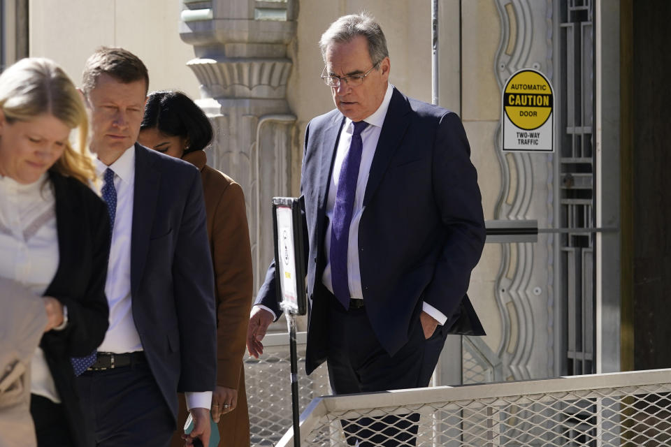 Mike Delaney, right, chief aerospace safety officer at the Boeing Company, walks out the federal court building after the arraignment of Boeing in Fort Worth, Texas, Thursday, Jan. 26, 2023. Boeing representatives and relatives of some of the passengers killed in two crashes of Boeing 737 Max jets met face-to-face in a Texas courtroom Thursday, where the aerospace giant was arraigned on a criminal charge that it thought it had settled two years ago. (AP Photo/LM Otero)