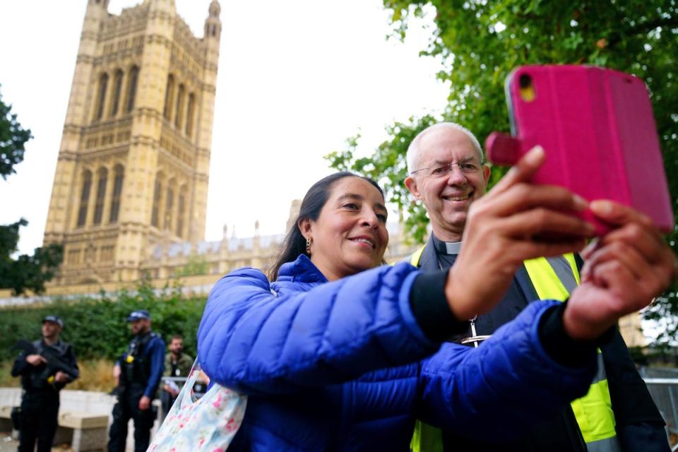 The Archbishop of Canterbury Justin Welby talks to people near the final section of the queue to see the coffin of Queen Elizabeth II outside the Palace of Westminster (PA)