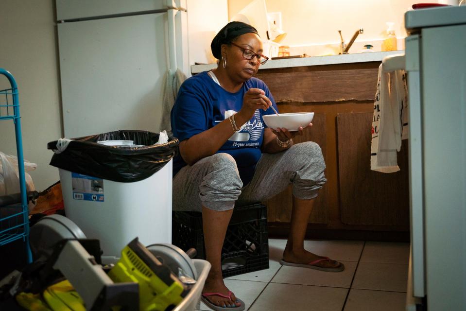 Tonya Hogan, 50, eats jambalaya for dinner at her apartment in Melvindale on Friday, July 14, 2023. The day before, Hogan experienced a breakdown from stress due to not hearing back from jobs she applied to, financial struggles covering $50 per month in rent, and the date of her late husband's birthday approaching. "I wish I could just do something to celebrate him, but I can't," said Hogan, whose car has been at the mechanic shop for months because she is unable to pay the price for repair.