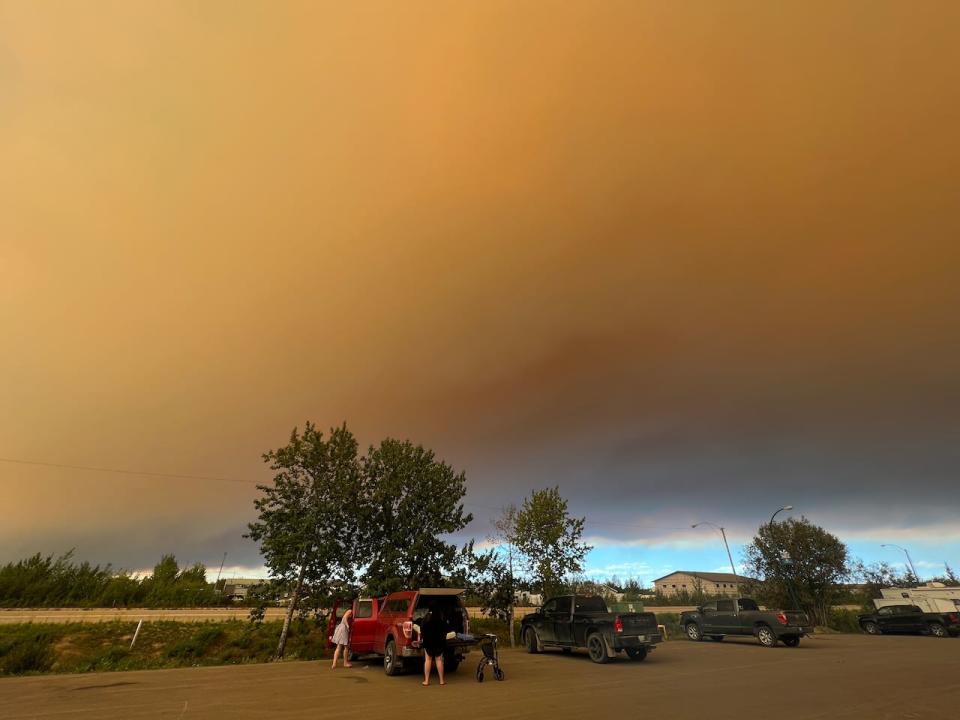 Evacuees prepare to leave Hay River on Aug. 12. The town's mayor is pleading for anyone remaining to get out while they still can. 