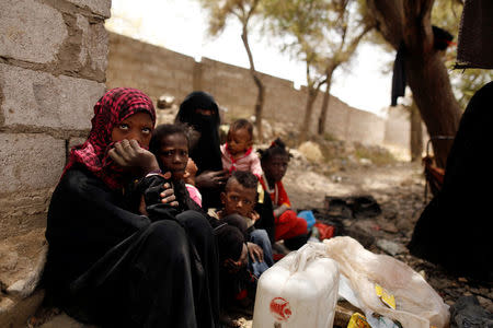 People displaced from the Red Sea port city of Hodeidah sit outside an a host family's house where they live on the outskirts of Sanaa, Yemen July 10, 2018. REUTERS/Khaled Abdullah