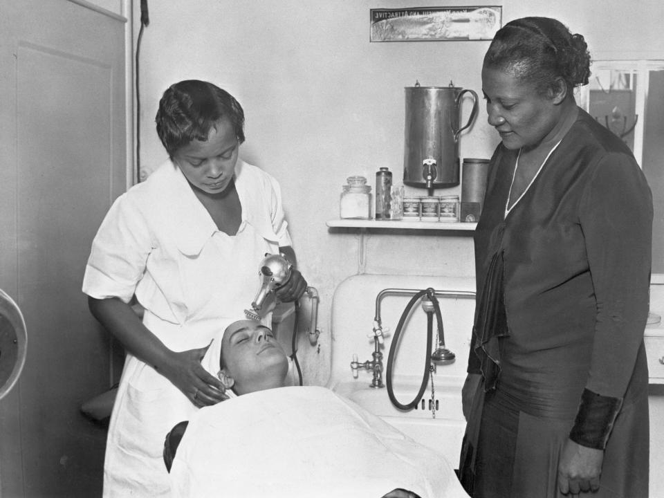 Black and white photos of Madam CJ Walker giving a tutorial, applying hair product to another woman.