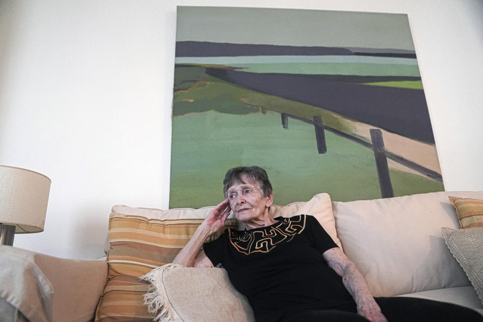 Ellen Ensig-Brodsky, 89, a LGBTQ rights activist, pose in her home, Wednesday, June 22, 2022, in New York. Even with ailing knees, Ensig-Brodsky said she plans to be on the Pride Parade route on Sunday. "The parade is the display, publicly, of my identity." (AP Photo/Bebeto Matthews)