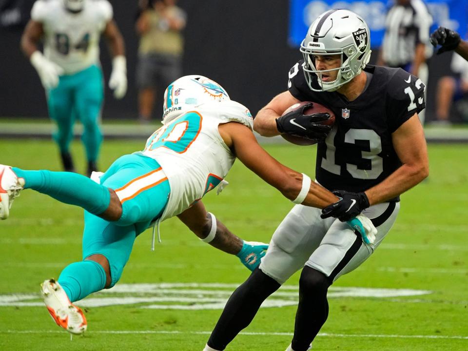 Hunter Renfrow breaks a tackle against the Miami Dolphins.