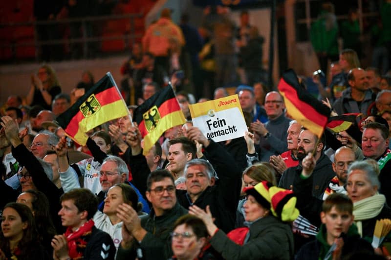 Germany fans cheer in the stands during the European Handball Championship Group A match between Germany and Switzerland  at the Merkur Spiel-Arena. Tom Weller/dpa