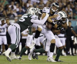 Philadelphia Eagles' Christian Hackenberg (8) fumbles the ball while being tackled by New York Jets' J.J. Wilcox (37) and Xavier Cooper (75) during the second half of a preseason NFL football game Thursday, Aug. 30, 2018, in Philadelphia. (AP Photo/Matt Rourke)