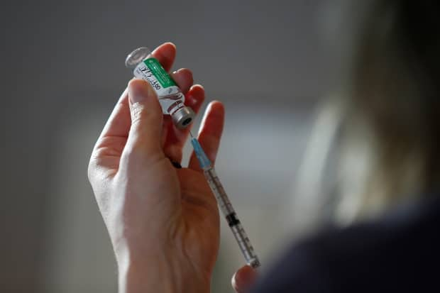 Dr. Joss Reimer, medical lead of the Manitoba Vaccine Implementation Task Force, draws a dose of the AstraZeneca COVID-19 vaccine at a clinic in Winnipeg on Friday, March 19, 2021. Nova Scotia reported five new cases of the virus on Sunday. (John Woods/The Canadian Press - image credit)