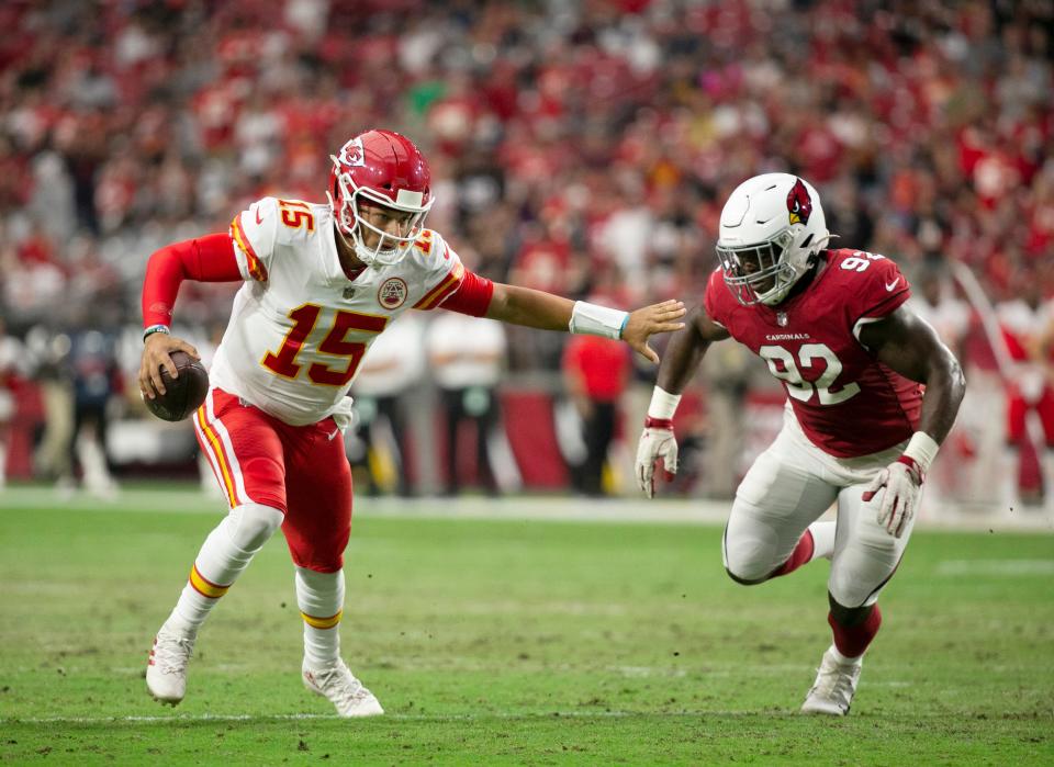 Chiefs quarterback Patrick Mahomes carries the ball as he is pursued by Cardinals linebacker Victor Dimukeje during the first half of the preseason game at State Farm Stadium in Glendale on August 20, 2021.