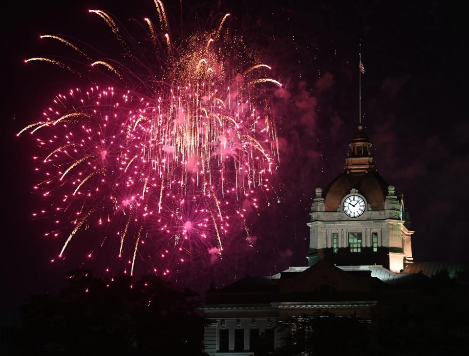 Fireworks go off behind the Brown County Courthouse during Fire over the Fox, Green Bay's Fourth of July celebration, on July 4, 2023, in Green Bay, Wis.