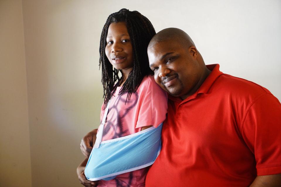 Trinity sits with her father Chris Neal.