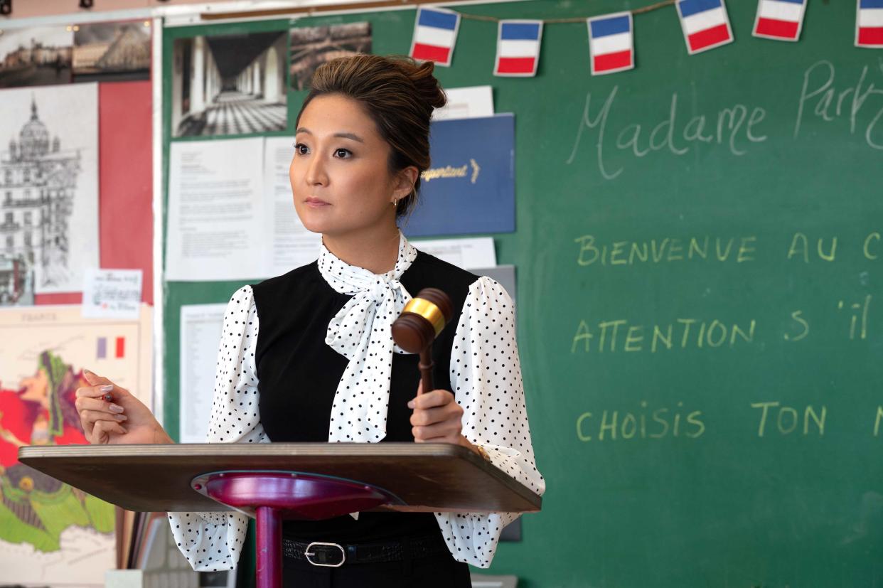 Ashley Park stands in a classroom in a scene from Mean Girls