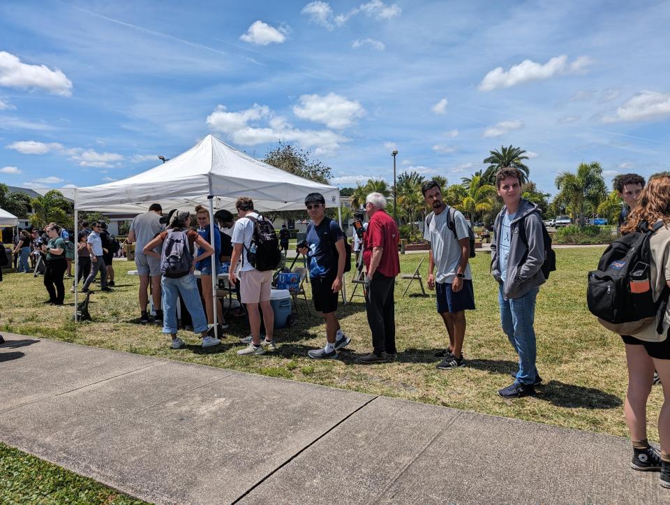 Florida Tech students line up to get eclipse-viewing glasses.