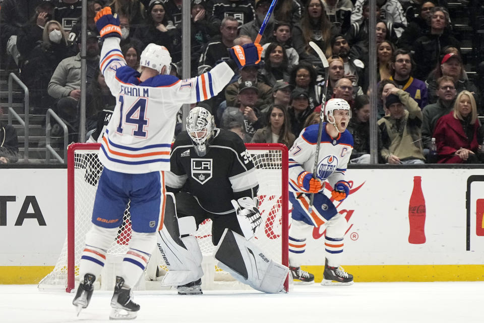 Edmonton Oilers center Connor McDavid, right, and defenseman Mattias Ekholm, left, celebrate a goal by center Leon Draisaitl as Los Angeles Kings goaltender Cam Talbot stands at goal during the second period of an NHL hockey game Saturday, Dec. 30, 2023, in Los Angeles. (AP Photo/Mark J. Terrill)