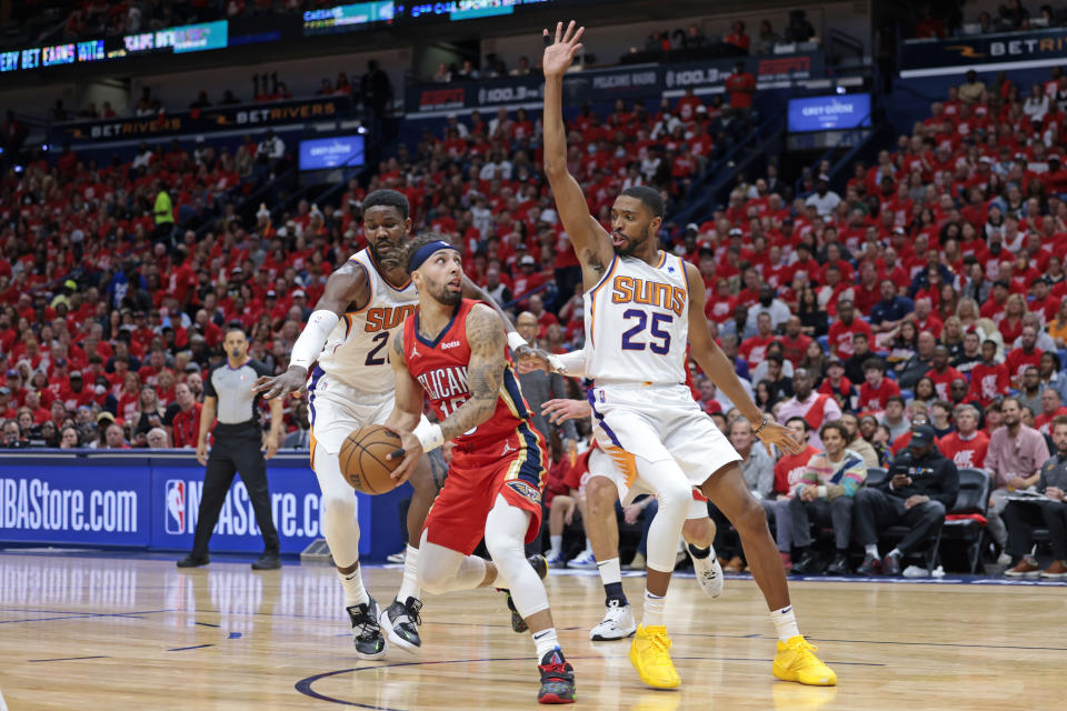 Phoenix Suns forward Mikal Bridges (25) defends against New Orleans Pelicans guard Jose Alvarado (15) during the first half of Game 3 of an NBA basketball first-round playoff series in New Orleans, Friday, April 22, 2022. (AP Photo/Michael DeMocker)