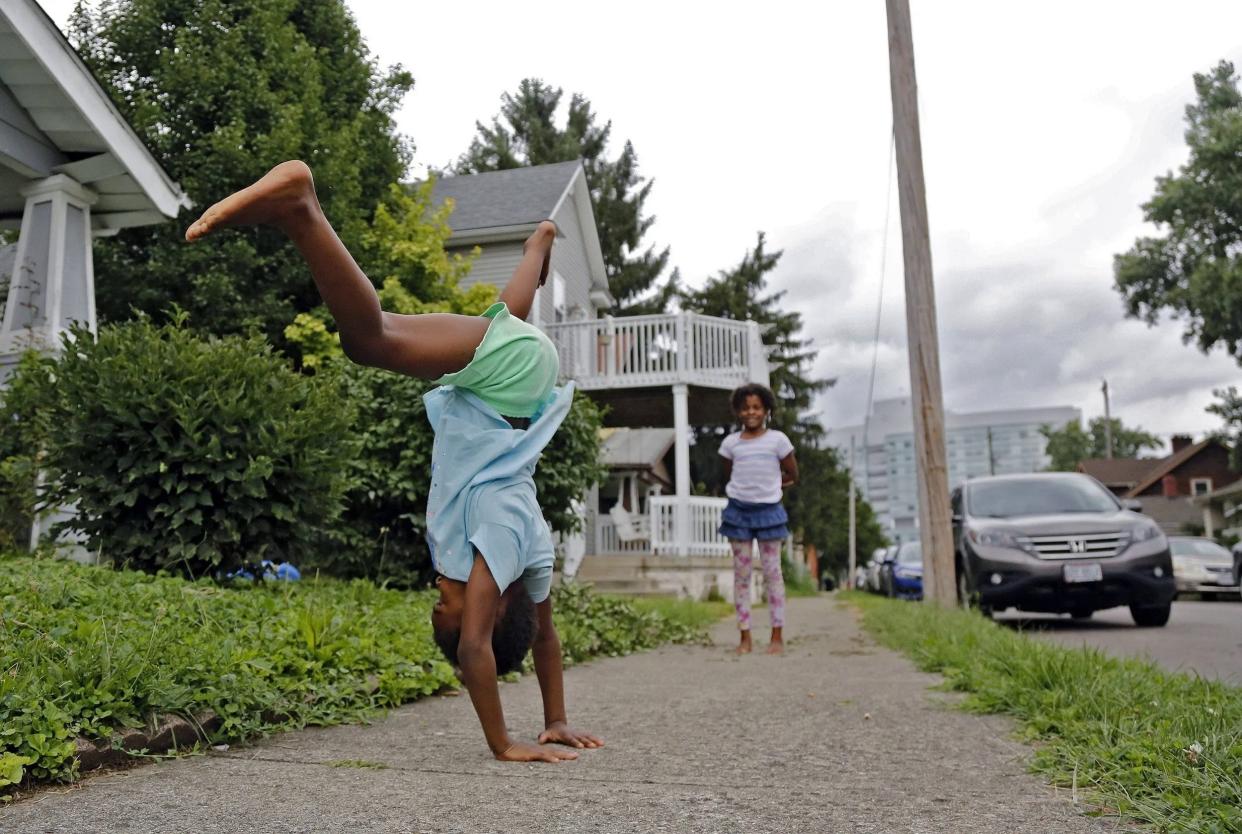 Tya Bryson does a cartwheel while Lailah Montgomery watches on Wagner Street facing north toward Nationwide Children’s Hospital. The hospital and it’s partners have pumped $22.6 million into renovating and building homes in the neighborhood through the Healthy Homes Program.