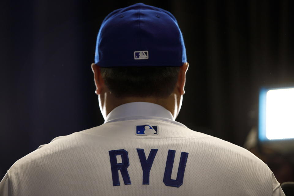 Toronto Blue Jays newly signed pitcher Hyun-Jin Ryu speaks to media while wearing his Blue Jays uniform for the first time at a newss conference announcing his signing to the team in Toronto, Friday, Dec. 27, 2019. (Cole Burston/The Canadian Press via AP)