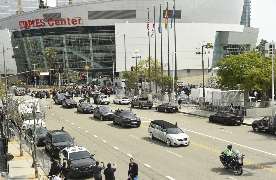 A silver hearse carrying the body of Nipsey Hussle, whose given name was Ermias Asghedom, leaves Staples Center in a procession following the Celebration of Life memorial service for the late rapper on Thursday, April 11, 2019, at the Staples Center in Los Angeles. (Photo by Chris Pizzello/Invision/AP)