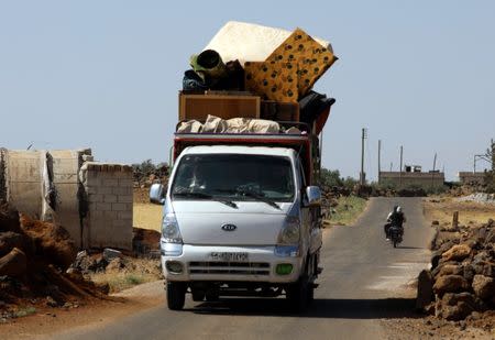 People ride in a truck loaded with belongings in Deraa countryside, Syria June 22, 2018. REUTERS/Alaa al-Faqir