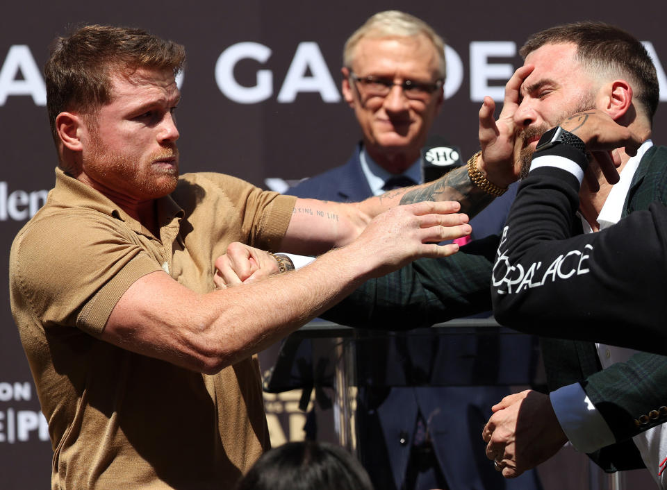 BEVERLY HILLS, CALIFORNIA - SEPTEMBER 21:  (L-R) Canelo Alvarez slaps Caleb Plant during a face-off before a press conference ahead of their super middleweight fight on November 6 at The Beverly Hilton on September 21, 2021 in Beverly Hills, California. (Photo by Ronald Martinez/Getty Images)