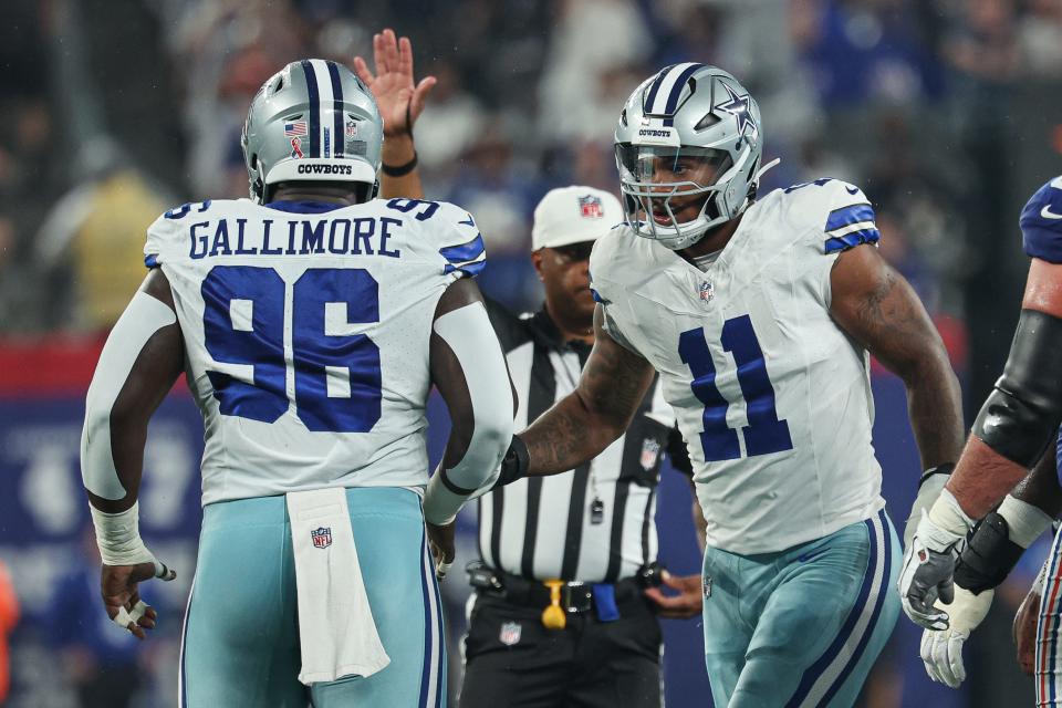 Dallas Cowboys linebacker Micah Parsons celebrates a defensive stop with defensive tackle Neville Gallimore.