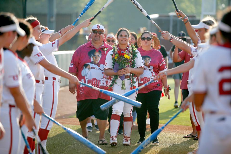 OU slugger Jocelyn Alo (center) is honored with her family during the Sooners' Senior Day festivities Saturday afternoon at Marita Hynes Field in Norman. Alo hit a grand slam to rally OU past OSU 5-3.