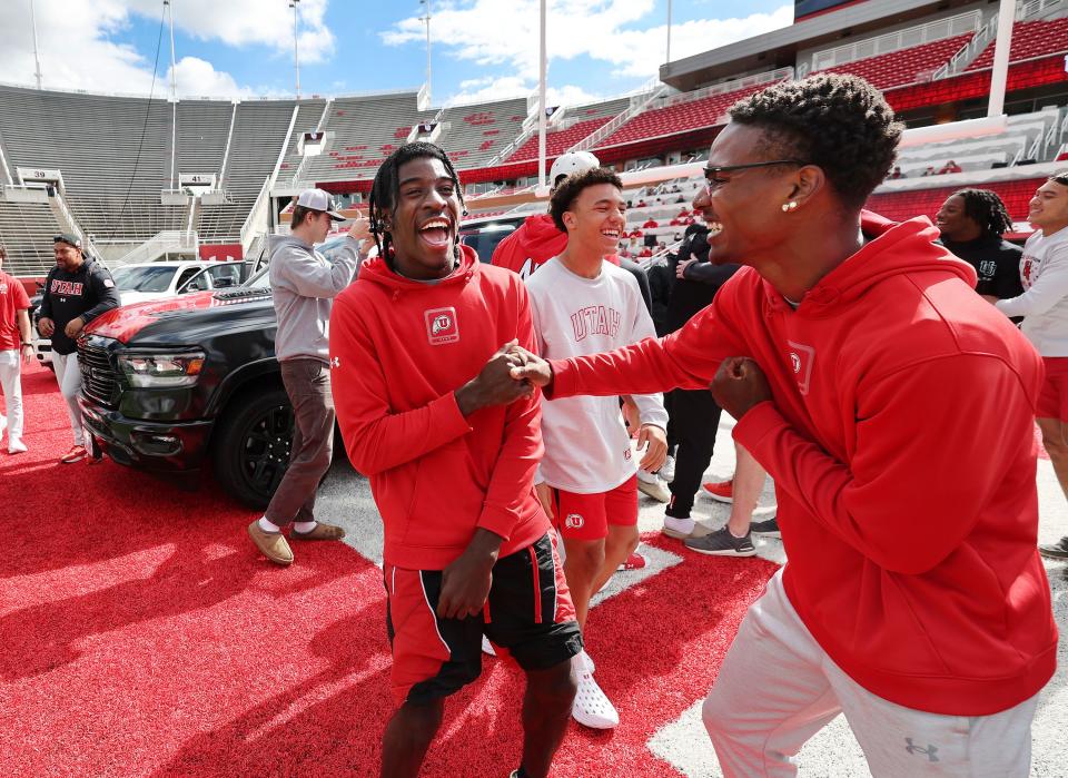 Utah Utes Daidren Zipperer, left, and C.J. Blocker celebrate getting a Dodge truck given to each player on the team by the Crimson Collective during an NIL announcement at Rice-Eccles Stadium in Salt Lake City on Wednesday, Oct. 4, 2023. | Jeffrey D. Allred, Deseret News