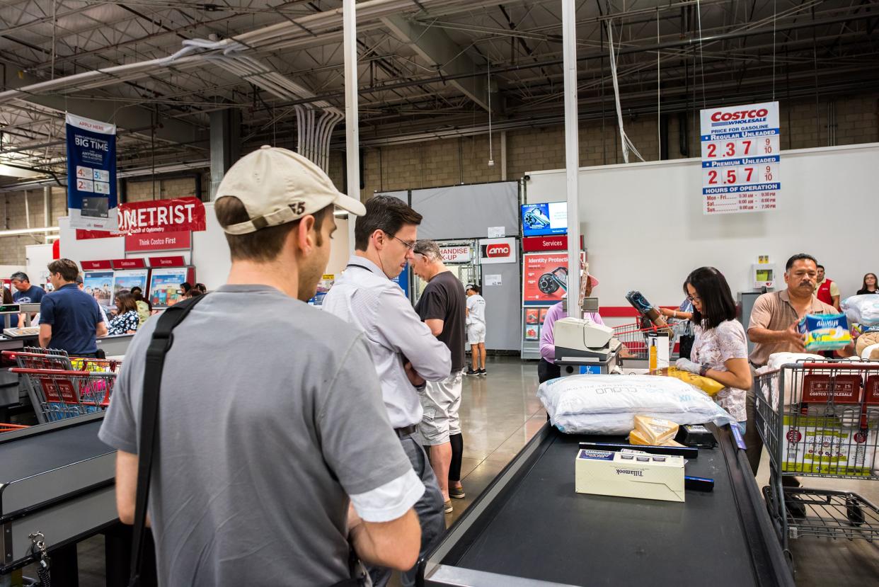 Customers waiting to pay at Costco checkout.