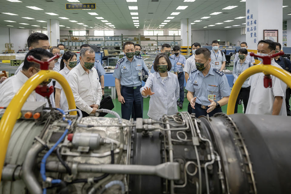 In this photo released by the Taiwan Presidential Office, Taiwan's President Tsai Ing-wen visits a factory producing parts for fighter jets in Hualien in eastern Taiwan on Tuesday, Sept. 6, 2022. Taiwanese President Tsai Ing-wen said Tuesday that China is conducting "cognitive warfare" by spreading misinformation in addition to its regular incursions into nearby waters and airspace intended at intimidating the self-governing island. (Taiwan Presidential Office via AP)