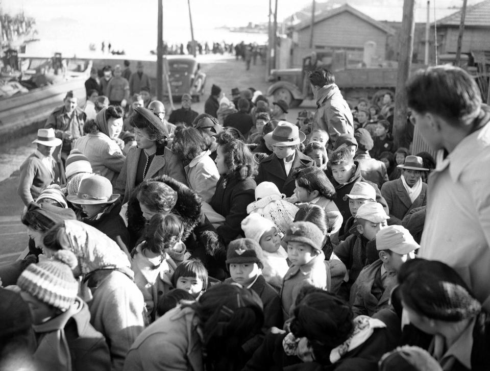 FILE - In this Jan. 5, 1946, file photo, following their arrival at Uraga, Japan, on Christmas Day, Japanese men, women and children repatriated from the United States are herded onto a truck for the three-mile trip to a reception center. More than 2,000 persons debarked at the port from the liner Matsonia. (AP Photo, File)