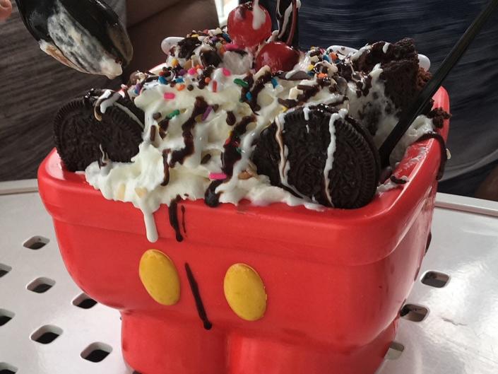 the kitchen sink sundae from beaches and cream at disney world complete with whipped cream, fudge, oreos, and sprinkles