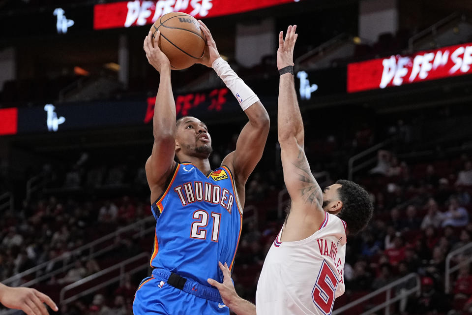 Oklahoma City Thunder guard Aaron Wiggins (21) shoots over Houston Rockets guard Fred VanVleet (5) during the first half of an NBA basketball game Wednesday, Dec. 6, 2023, in Houston. (AP Photo/Kevin M. Cox)