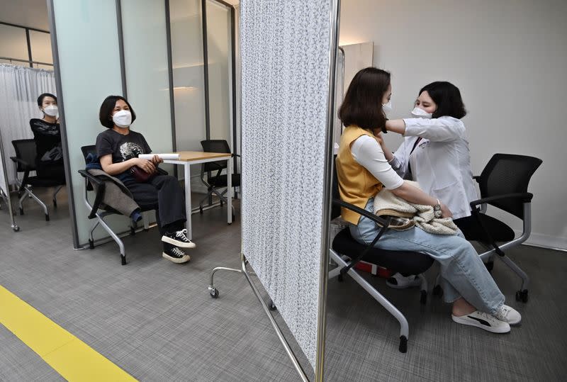 A medical worker receives the second dose of the Pfizer-BioNTech coronavirus disease (COVID-19) vaccine at a vaccination centre in Seoul, South Korea