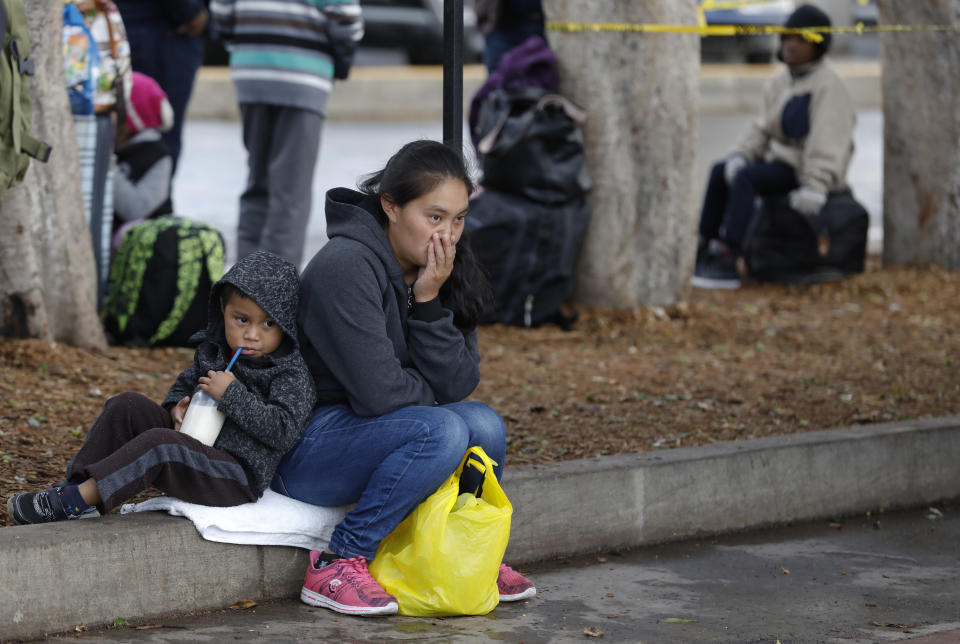 Migrants wait for a chance to request U.S. asylum, alongside the El Chaparral pedestrian border crossing in Tijuana, Mexico, Friday, Nov. 30, 2018. Authorities in the Mexican city of Tijuana have begun moving some of more than 6,000 Central American migrants from an overcrowded shelter on the border to an events hall further away.(AP Photo/Rebecca Blackwell)