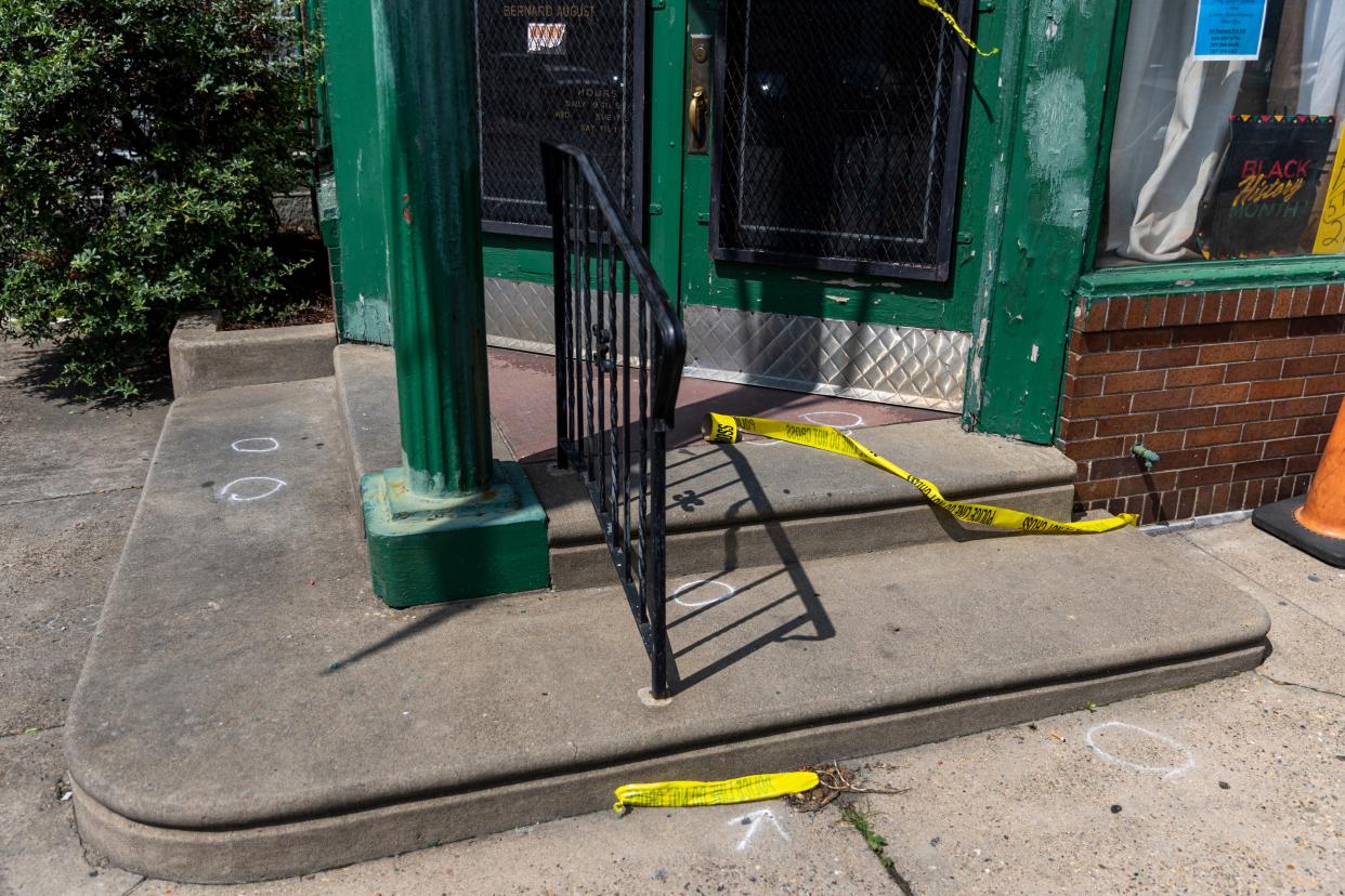 Evidence markers and police tape are left at the scene of a Monday night shooting in Philadelphia (Tyger Williams/The Philadelphia Inquirer)