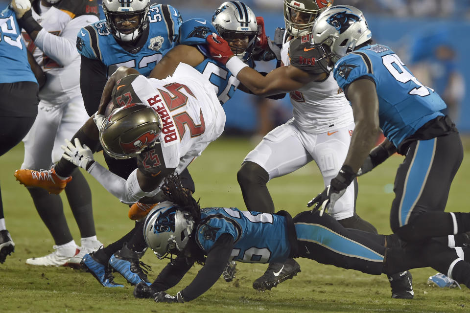 Tampa Bay Buccaneers running back Peyton Barber (25) is upended by Carolina Panthers cornerback Donte Jackson during the first half of an NFL football game in Charlotte, N.C., Thursday, Sept. 12, 2019. (AP Photo/Mike McCarn)