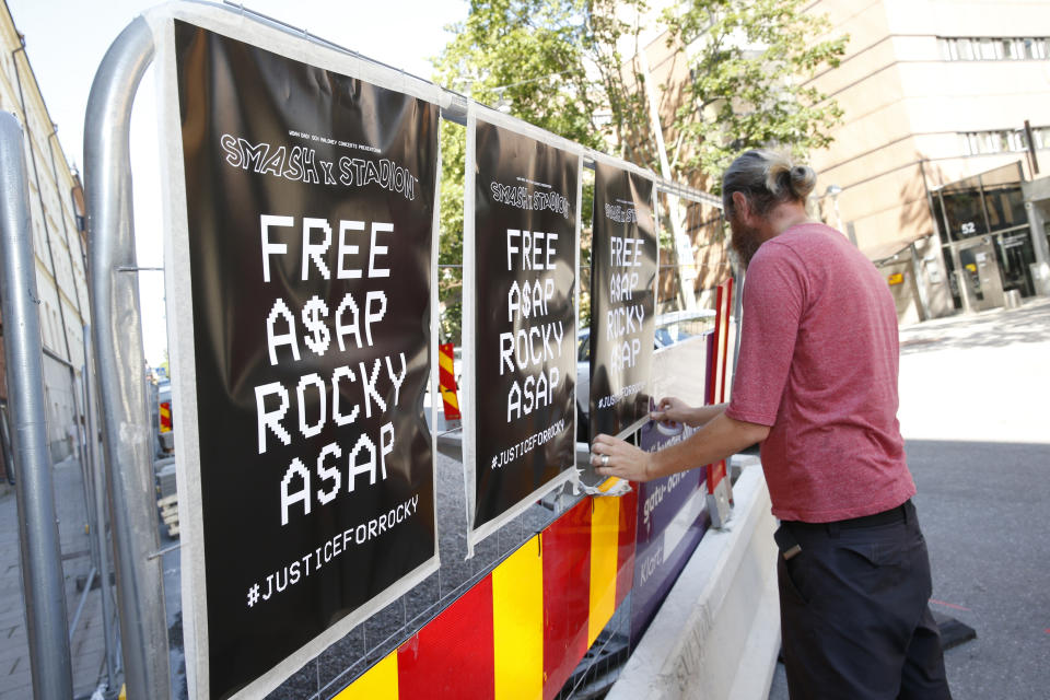 A man displays posters in support of US rapper A$AP Rocky, real name Rakim Mayers, outside the Kronoberg custody in Stockholm, Sweden, Thursday, July 25, 2019. A Swedish prosecutor on Thursday charged rapper A$AP Rocky, with assault over a fight in Stockholm last month, in a case that's drawn the attention of fellow recording artists as well as U.S. President Donald Trump. (Fredrik Persson/TT News Agency via AP)