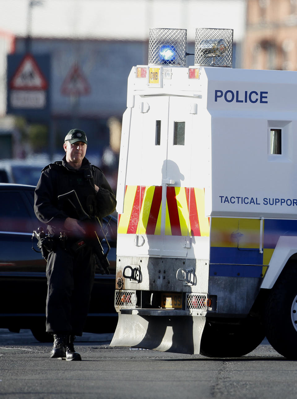 A police officer patrols the area close to where a prominent dissident republican was shot dead in west Belfast, Northern Ireland, Friday, April, 18, 2014. A senior Irish Republican Army hard-liner has been shot to death in Belfast three years after former comrades in his splinter group threatened to kill him. Nearby residents say gunmen escorted the victim, 43-year-old Tommy Crossan, to a fuel depot overlooked by houses and shot him in the head and body at close range. No group claimed responsibility. Police and politicians blamed Crossan’s former group, the Continuity IRA, for following through on 2011 death threats against him. The Continuity IRA accused him of keeping money from robberies and providing information on colleagues to British intelligence agents. Crossan denied this and refused to flee his native Catholic west Belfast. The major IRA faction, the Provisionals, renounced violence in 2005 but other militant groups remain active. Their last killing was in October. (AP Photo/Peter Morrison)