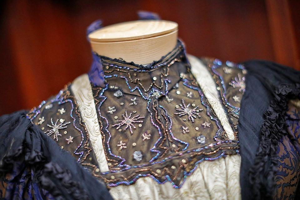 A brown and blue silk brocade dress with black chiffon ruffle trim and beaded embroidery is part of the exhibit "Flounces, Furbelows and Fripperies: The Gilded Age in Cohasset," which will open Jan. 14 at the Cohasset Historical Society at 104 S. Main St.