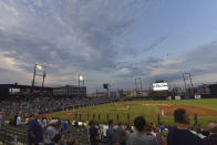 FILE - Players stand during the national anthem before the Rosemont Dogs played their baseball home-opener against the Milwaukee Milkmen at Impact Field in Rosemont, Ill., in this Tuesday, July 7, 2020, file photo. Minor league teams across the country are set to open their seasons Tuesday, May 4, 2021, returning baseball to communities denied the old national pastime during the coronavirus pandemic. (John Starks/Daily Herald, via AP, File)