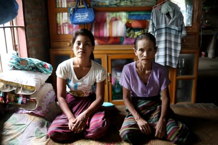 Kyu Kyu Win, 31, who says she was abused by her husband, and has moved out and is staying with her mother, is photographed in Dawei