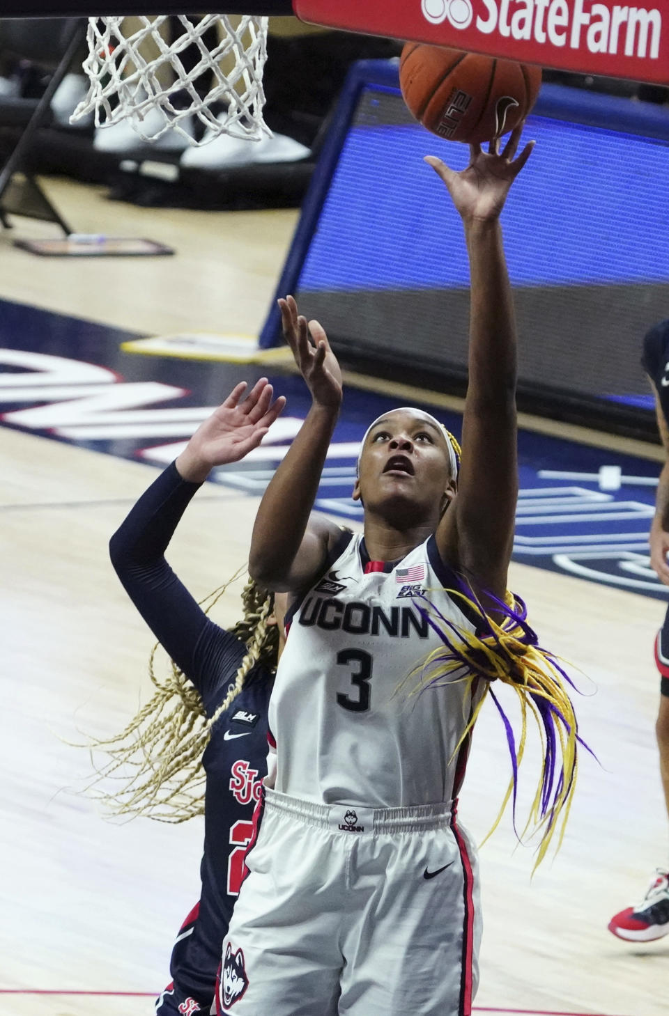 Connecticut forward Aaliyah Edwards (3) shoots in front of St. John's forward Rayven Peeples (20) during the second half of an NCAA college basketball game Wednesday, Feb. 3, 2021, in Storrs, Conn. (David Butler II/Pool Photo via AP)