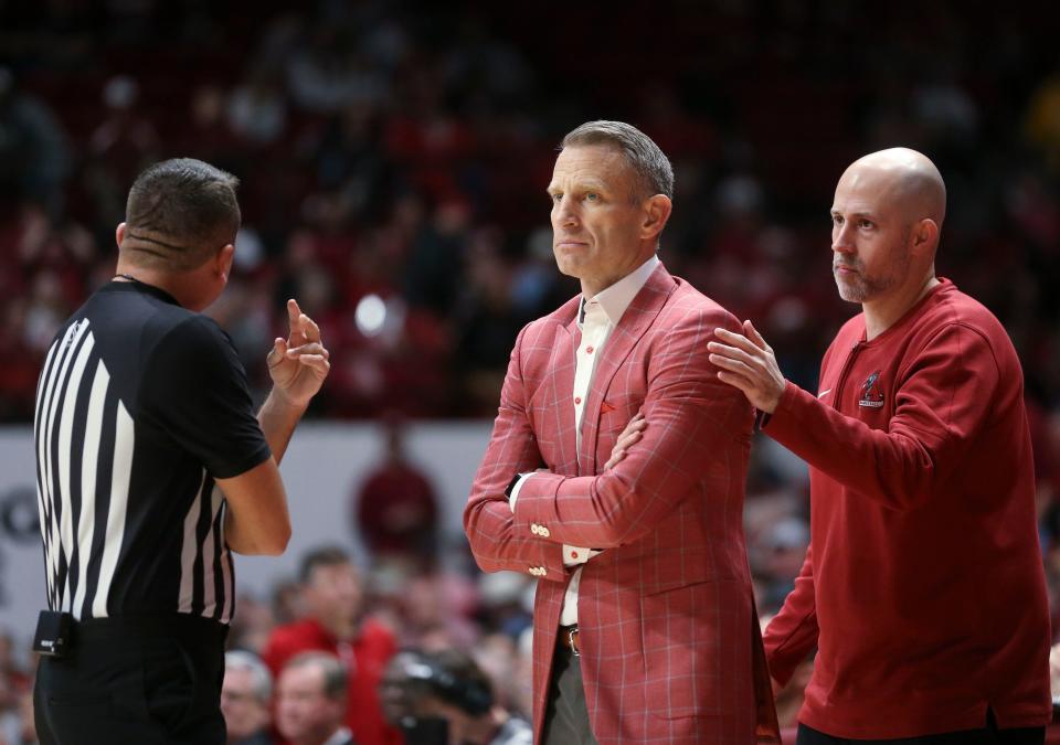 Alabama assistant coach Ryan Pannone puts a calming hand on head coach Nate Oats’ shoulder as Oats has a dispute with an official during a game vs. Arkansas, March 9, 2024 in Tuscaloosa, Alabama.